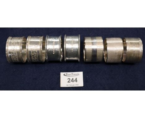 Collection of assorted napkin rings, two pairs in silver, another engine turned silver and pair of white metal marked HMS Ord