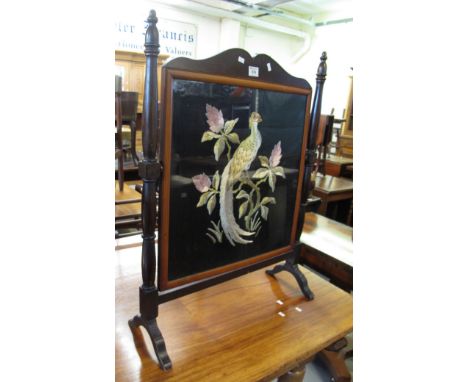 Early 20th Century swivel firescreen, the tapestry decorated with peacock amongst foliage. (B.P. 24% incl. VAT)
