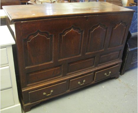 18th Century oak coffer having moulded top above four pointed ogee moulded panels, with three fitted drawers on bracket feet.