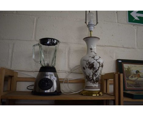 A Tower Juicer/Blender together with a ceramic lamp