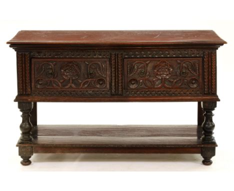 A carved and dark stained oak dresser, late 19th/early 20th century, in 17th century English style, fitted with two drawers c