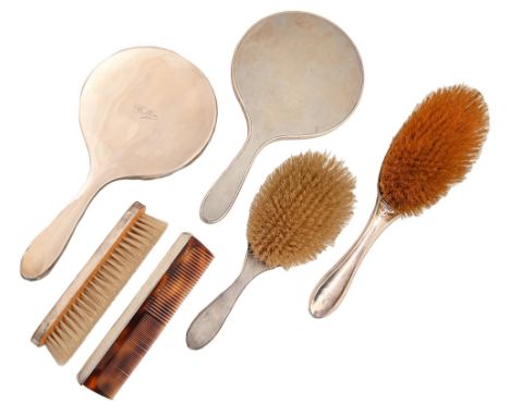An Elizbeth II four piece silver brush set, engine turned, maker DCBs, London 1963 and a silver hairbrush and hand mirror (6)