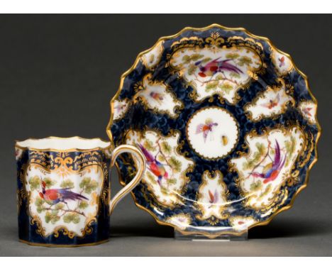 A Grainger's Worcester fluted scale blue ground coffee cup and saucer, 1891, painted with reserves of 'Fancy Birds' and gilt,