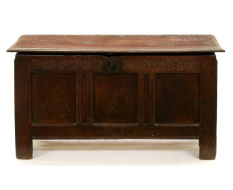 An English oak chest, late 17th c,&nbsp; the lid with moulded lip above three panel front with lunette carved frieze and iron