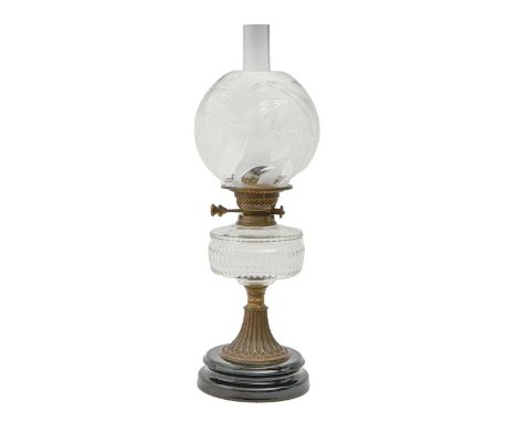 An Edwardian brass oil lamp, with black glazed earthenware foot and cut glass reservoir, brass burner and a glass globe shade