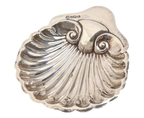 An Edwardian silver butter shell,&nbsp;on ball feet, 13cm l, by James Deakin &amp; Sons, Sheffield 1904, 1ozs 11dwts  Light w