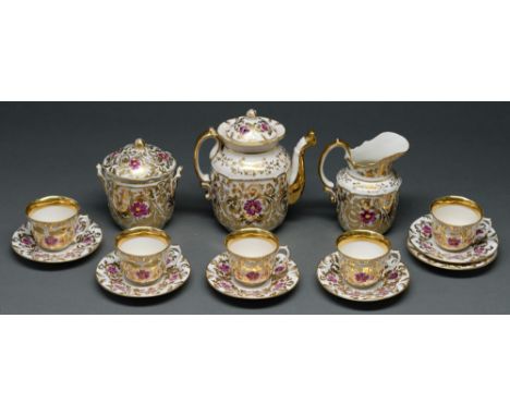 A French porcelain tea service, c1860, painted with puce flowers amidst richly gilt scrolling foliage, teapot and cover 19cm 