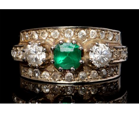 An emerald and diamond ring, the 5 x 5mm emerald flanked by two round brilliant cut diamonds above three lines of old cut dia