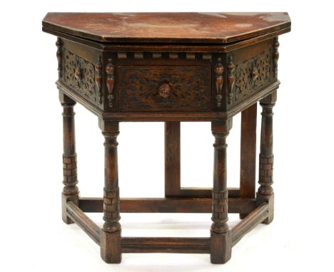 An oak table, early 20th c,&nbsp;in William and Mary style, the spayed fold-over top above blind carved drawers and split bal