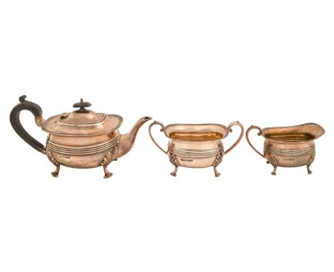 A George V silver tea service, on four scroll feet, teapot 15cm h, by Jenkins &amp; Timm, Sheffield 1922, 43ozs 3dwts (3)  Go