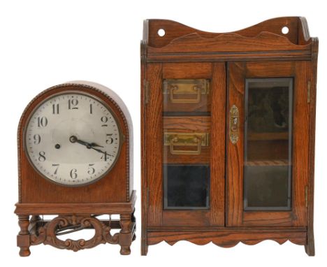 A German oak mantel clock, c1925, with silvered dial and gong striking movement, in arched case, 33cm h and an Edwardian oak 