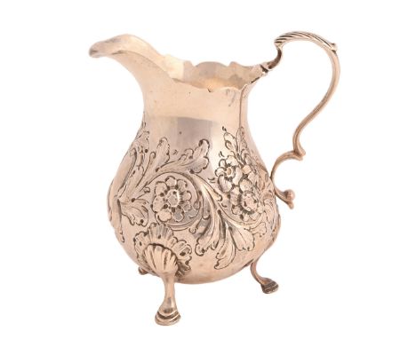 A George III silver cream jug, on three hoof feet, later chased, 10cm h, maker AF, probably Andrew Fogelberg, London 1784, 2o
