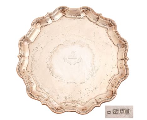 An Edwardian silver salver, on three volute feet, crested, 26cm diam, by Thomas Bradbury, London 1904, 22ozs 15dwts  Light po