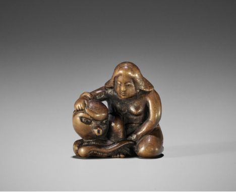 A RARE WOOD SHUNGA NETSUKE OF AN AMA WITH AMOROUS OCTOPUS  UnsignedJapan, 19th century, Edo period (1615-1868)The unlikely co