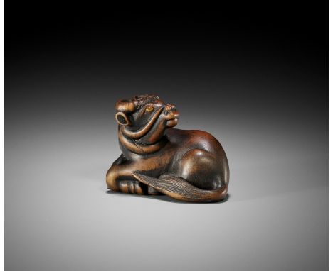 TOYOKAZU: A SUPERB WOOD NETSUKE OF A RECUMBENT OXBy Shugasai Toyokazu, signed Toyokazu 豊一Japan, Sasayama, Tanba province, mid