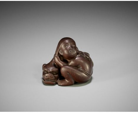 A FINE EDO SCHOOL WOOD NETSUKE OF A BOY WITH SHISHIMAI MASK  Signed with a kakihanJapan, Edo (Tokyo), 19th century, Edo perio