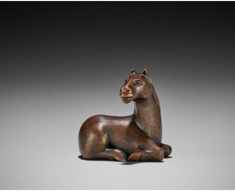 A FINE WOOD NETSUKE OF A RECUMBENT HORSEAttributed to Shinzan Masanao (born 1904), unsignedJapan, Ise-Yamada, 20th centuryFin