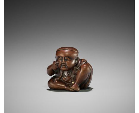 RYUGYOKU: A FINE WOOD NETSUKE OF A BOY WITH A BUAKU MASK  By Ryugyoku, signed Ryugyoku 龍玉Japan, Edo/Tokyo, second half of 19t