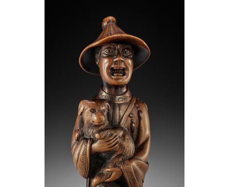 A VERY LARGE AND SUPERB WOOD NETSUKE OF A FOREIGNER WITH DOGUnsignedJapan, c. 1800, Edo period (1615-1868)Published: Barry Da