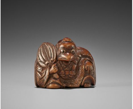 A FINE WOOD NETSUKE OF A KARASU TENGU  UnsignedJapan, 19th century, Edo period (1615-1868)The crow-beaked tengu seated with o