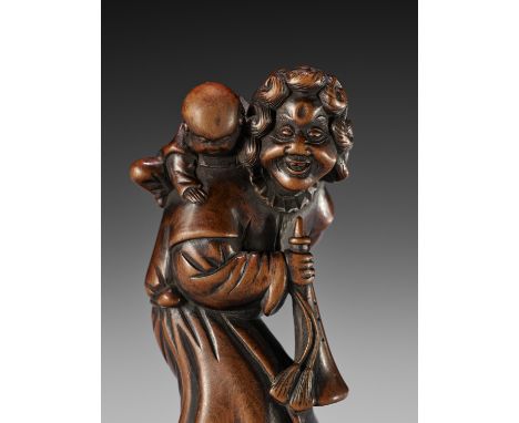 A GOOD WOOD NETSUKE OF A DUTCHMAN WITH CHILDUnsignedJapan, 18th century, Edo period (1615-1868)Typically depicted with should