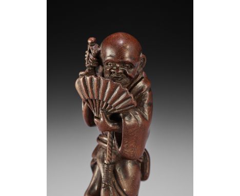 MINKO: A RARE TALL WOOD NETSUKE OF AN ITINERANT MONKBy Tanaka Juntoku Minko (1735-1816), signed Gose Minko 珉江 with kakihanJap