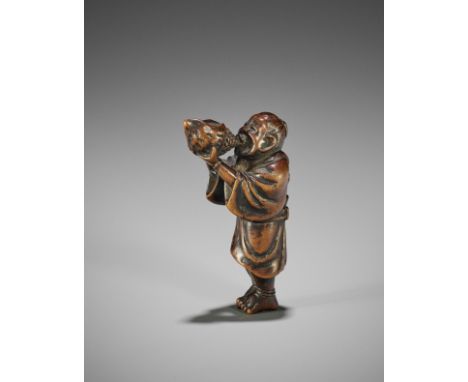 HOKKYO SESSAI: A WOOD NETSUKE OF A YAMABUSHI BLOWING ON A CONCH  By Hokkyo Shima Sessai (1820-1879), signed Sessai 雪斎 to 刀Jap
