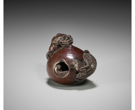 A RARE WOOD NETSUKE OF A DRAGON EMERGING FROM A TAMAUnsignedJapan, Nagoya, late 18th century, Edo period (1615-1868)A remarka