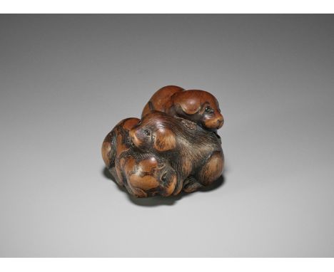 TOYOKAZU: A FINE WOOD NETSUKE OF THREE PLAYING PUPPIESBy Shugasai Toyokazu, signed Toyokazu 豊一Japan, Sasayama, Tanba province