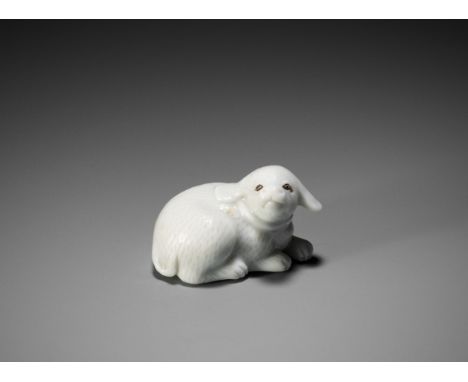 AN EXQUISITE HIRADO PORCELAIN NETSUKE OF A PUPPYUnsignedJapan, 19th centuryFinely and sensitively modeled, the recumbent dog 