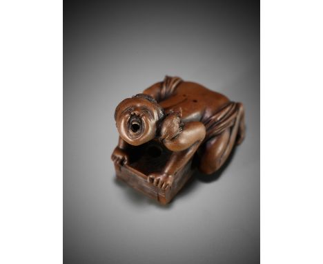 AN UNUSUAL SHUNGA WOOD NETSUKE OF OKAME AS A RAT CATCHERUnsignedJapan, 19th century, Edo period (1615-1868)A humorous wood ne
