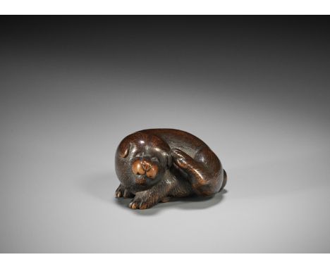 MASANAO: A FINE WOOD NETSUKE OF A PUPPY SCRATCHING ITS EARBy Masanao, signed Masanao 正直Japan, Ise-Yamada, mid-19th century, E