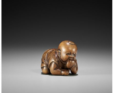 A YAMADA SCHOOL WOOD NETSUKE OF A CHUBBY BOY EATING MOCHI  UnsignedJapan, Ise-Yamada, mid-19th century, Edo period (1615-1868