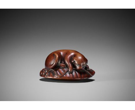 HOSHIN: A WOOD NETSUKE OF A PUPPY ON AWABIBy Hoshin, signed Hoshin 奉真Japan, Kyoto, late 18th to early 19th century, Edo perio