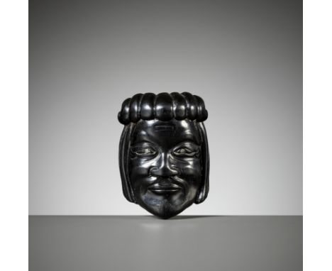 A RARE EBONY GYODO (RELIGIOUS) MASK NETSUKE OF DOKENInscribed Doken 道顕 Japan, 18th century, Edo period (1615-1868)Boldly carv
