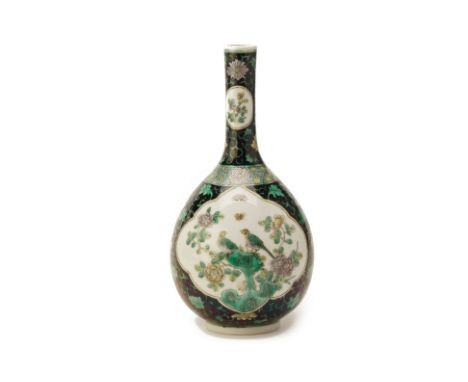 A FAMILLE NOIRE PORCELAIN BOTTLE VASE
Bears six character Kangxi mark to base, but later 
The shaped panels featuring birds p