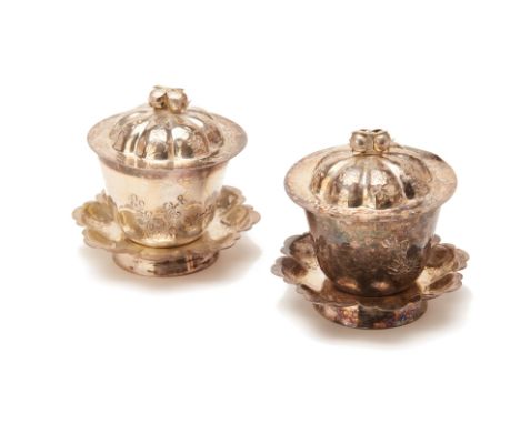 A PAIR OF CHINESE WHITE METAL TEA BOWLS, COVERS AND STANDS
The stand with scalloped rim and engraved foliate design, the tea 