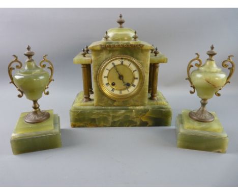 A FRENCH ONYX AND GILT METAL CLOCK GARNITURE, architectural style timepiece with acorn finials and dial flanking reeded colum
