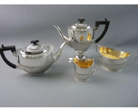 A SILVER TEA AND COFFEE SERVICE each piece of oval form with half reeded decoration to the bodies, composition handles to the