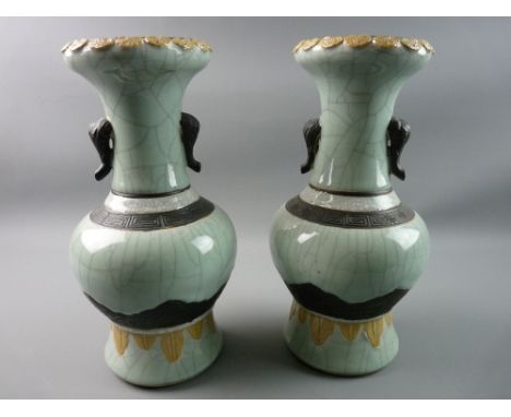 A PAIR OF ORIENTAL CELADON CRACKLE GLAZED NARROW NECKED BULBOUS VASES with elephant trunk handles and base marks for early 20