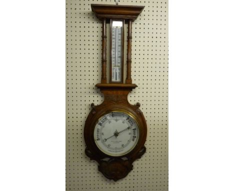 AN OAK FRAMED ANEROID BAROMETER WITH THERMOMETER, the dial marked 'W Williams Jones, Carnarvon', 77 cms long