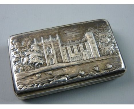 A NATHANIEL MILLS CASTLE TOP SILVER SNUFF BOX of rectangular form with gilt interior showing Newstead Abbey with a lattice de