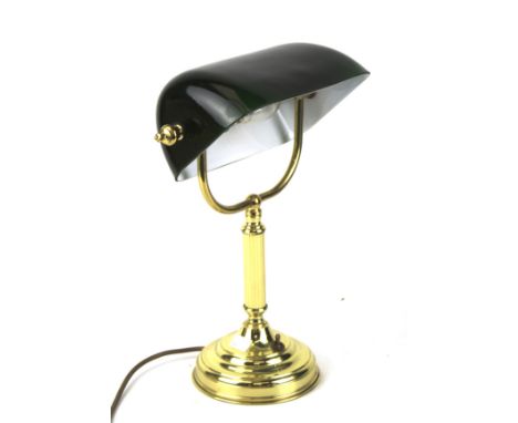 A vintage desk lamp. The brass frame supporting a black glass shade, H36cm