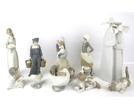 A collection of Lladro and Nao figures. Including nuns, two cats, a cherub, etc max H33cm.