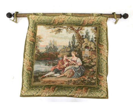 A 20th century needlepoint wall tapestry. Depicting a couple courting, attached to a pole, 90cm x 90cm (excluding pole)