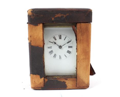 A French brass carriage clock in a fitted leather travelling case. The white dial with Roman numerals, glass panels to each s