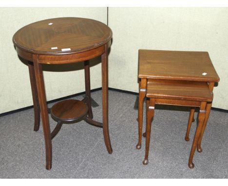 A Georgian style nest of two side tables and a circular table with a shelf. The mahogany inlaid circular table 73cm high 51cm