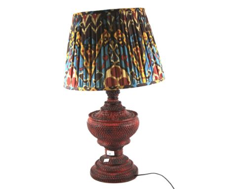 A large red cinnabar lacquered table lamp. Of baluster form, with a colourful shade, H45cm (excluding fitting)