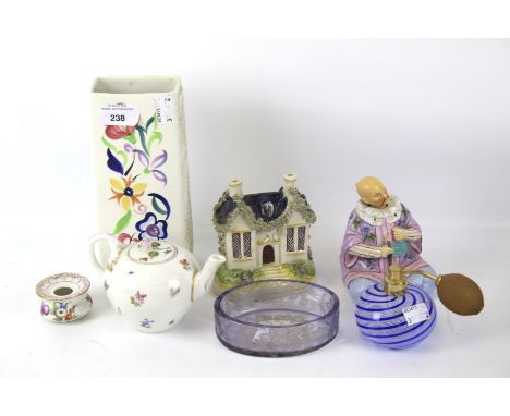 An assortment of glass and ceramics. Including a Poole pottery vase, nodding figure, scent bottle, etc.