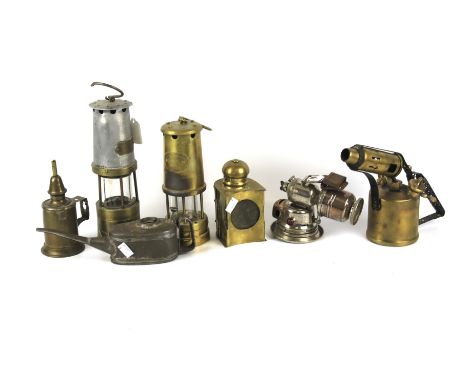 An assortment of metalware. Including miners lamps, bicycle light, blow lamp, etc.